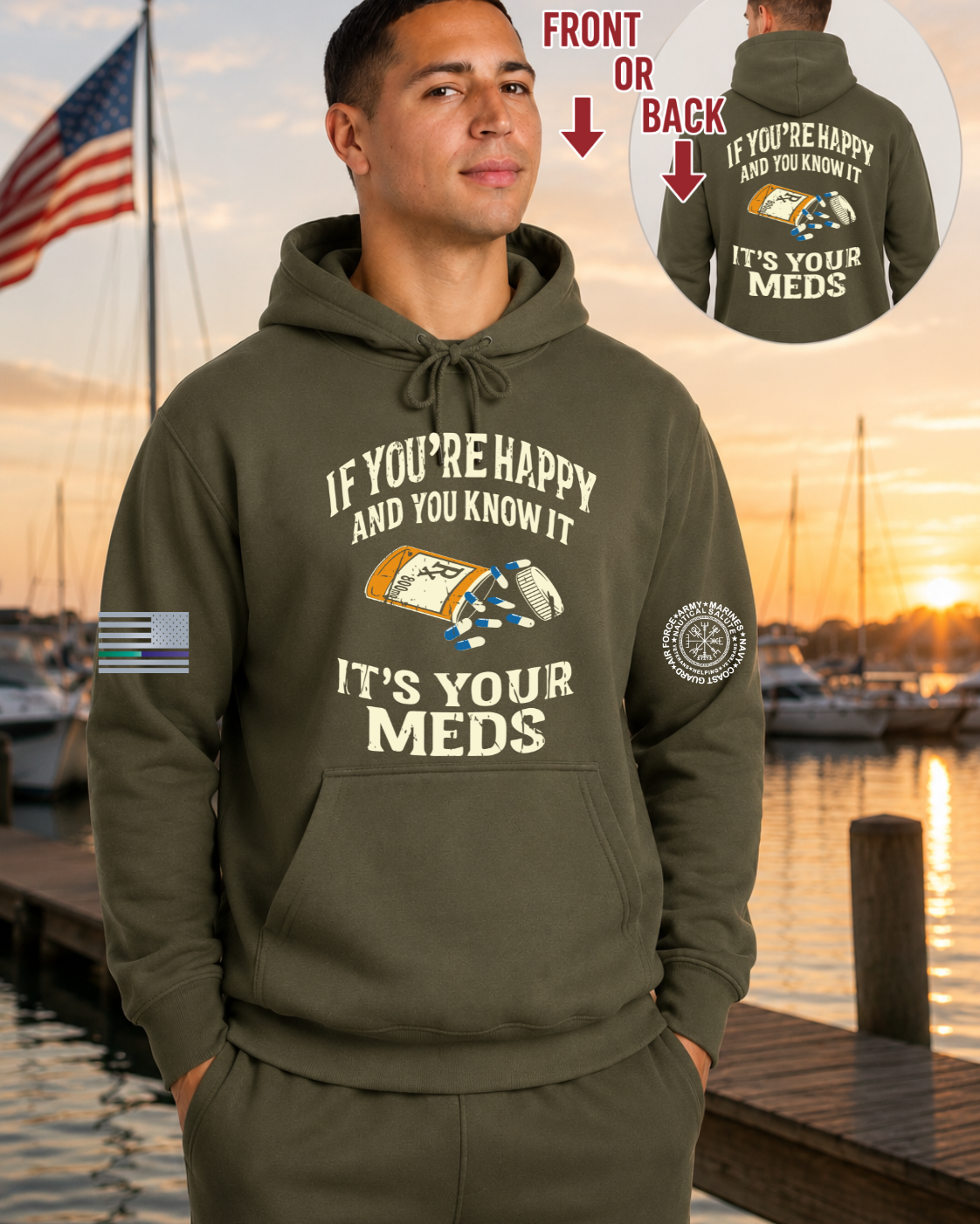 A man wearing an olive green hoodie with a medical-themed graphic on the front, standing by a waterfront at sunset. The hoodie has white text reading 'IF YOU'RE HAPPY AND YOU KNOW IT IT'S YOUR MEDS' with a pill bottle and pill box illustration.