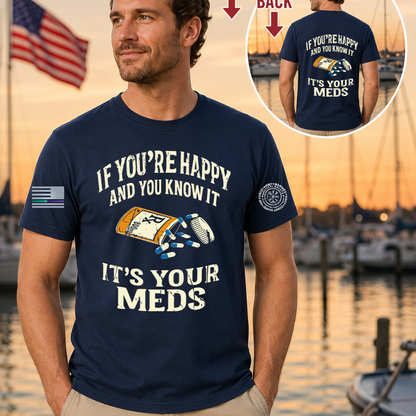 Man wearing a navy blue t-shirt with a humorous graphic and text, standing by a marina.