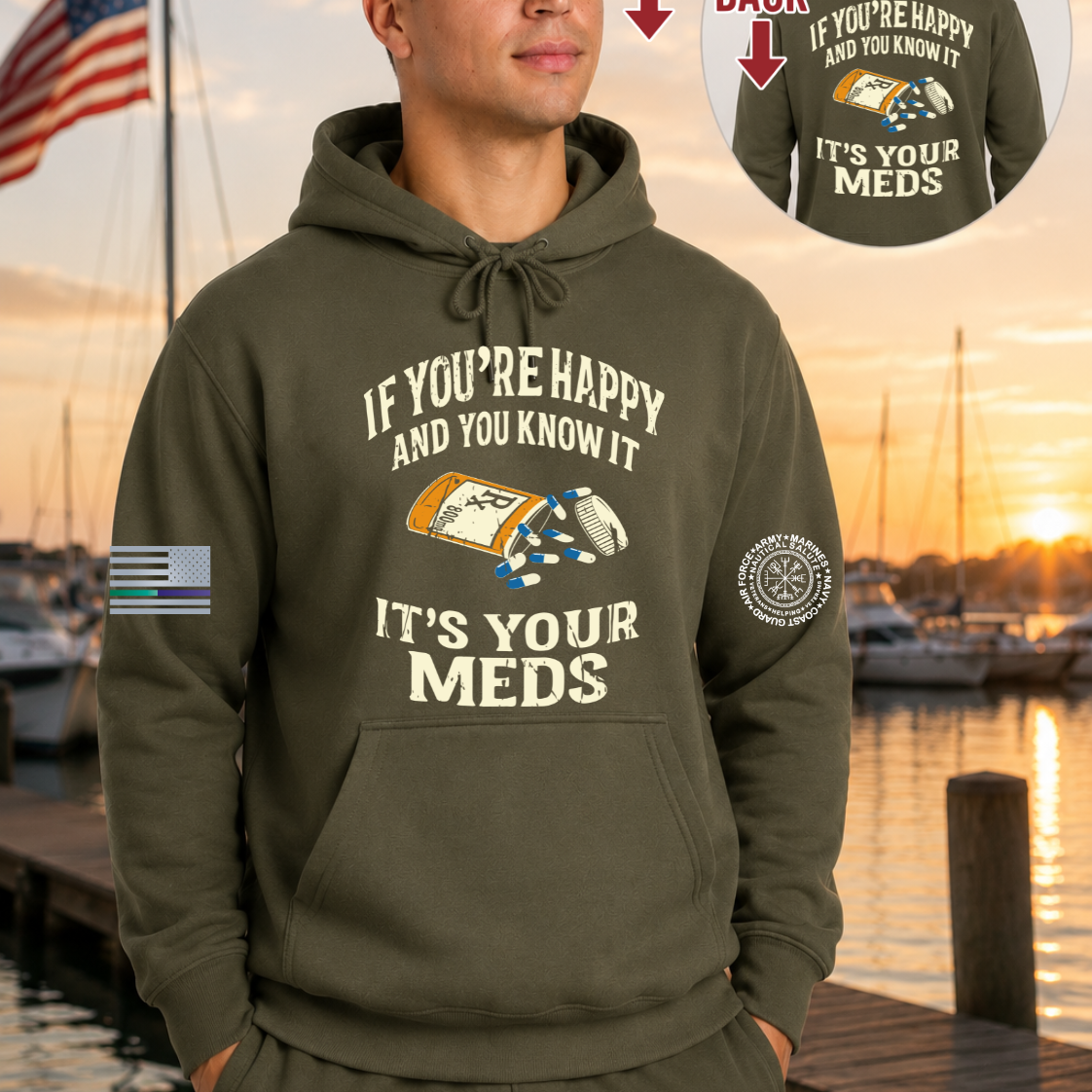 A man wearing an olive green hoodie with a medical-themed graphic on the front, standing by a waterfront at sunset. The hoodie has white text reading 'IF YOU'RE HAPPY AND YOU KNOW IT IT'S YOUR MEDS' with a pill bottle and pill box illustration.