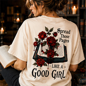 Person wearing a t-shirt with a graphic design and text, sitting in a cozy room.