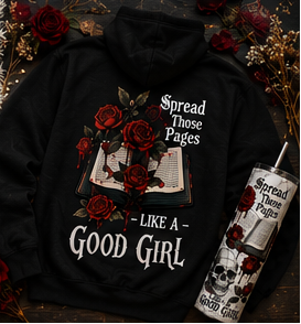 Black hoodie, beige t-shirt, and tumblers with floral and text design on a textured surface.